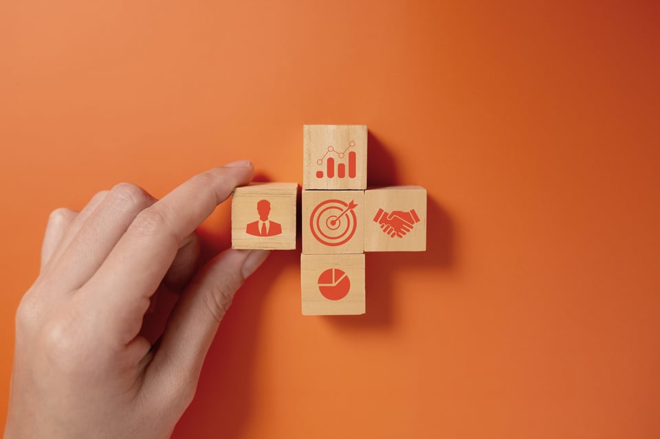 hand-putting-business-icons-on-wooden-cubic-blocks-2024-10-10-23-44-59-utc